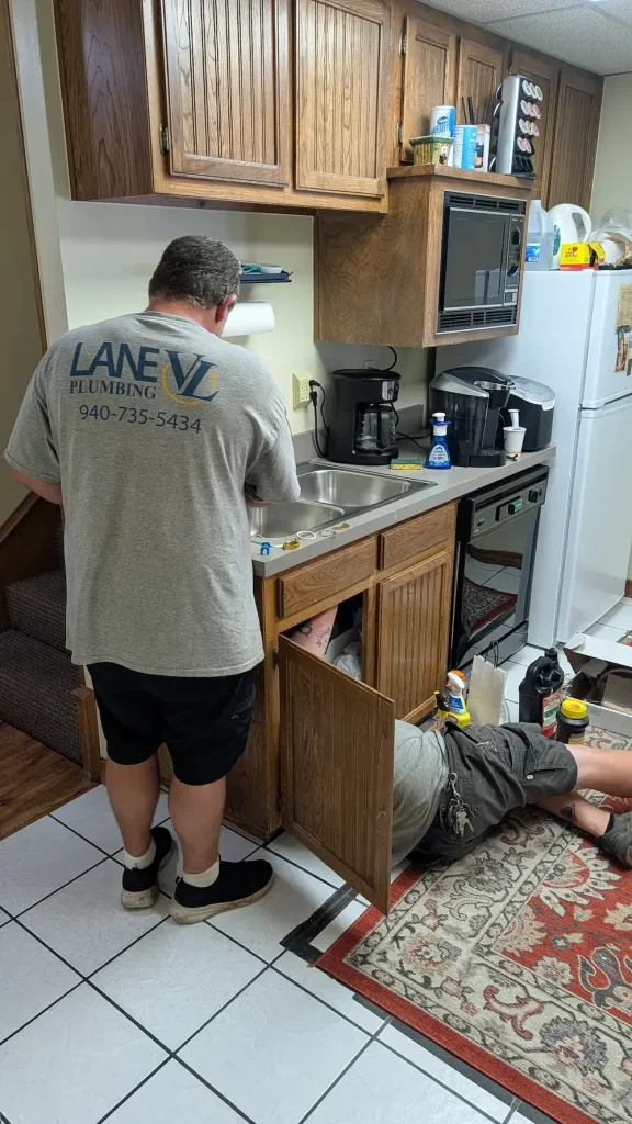 Lane VL plumbers working on replacing a faucet.